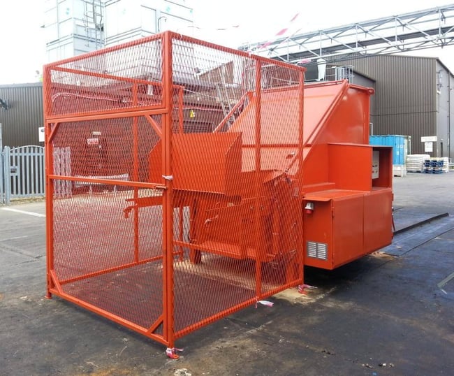 Rear-loading static compactor with bin lifter and safety cage