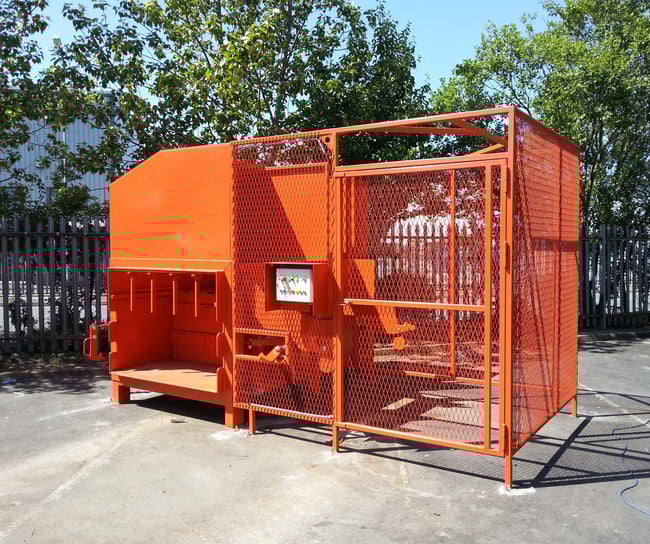 Static compactor with bin lifter and safety cage